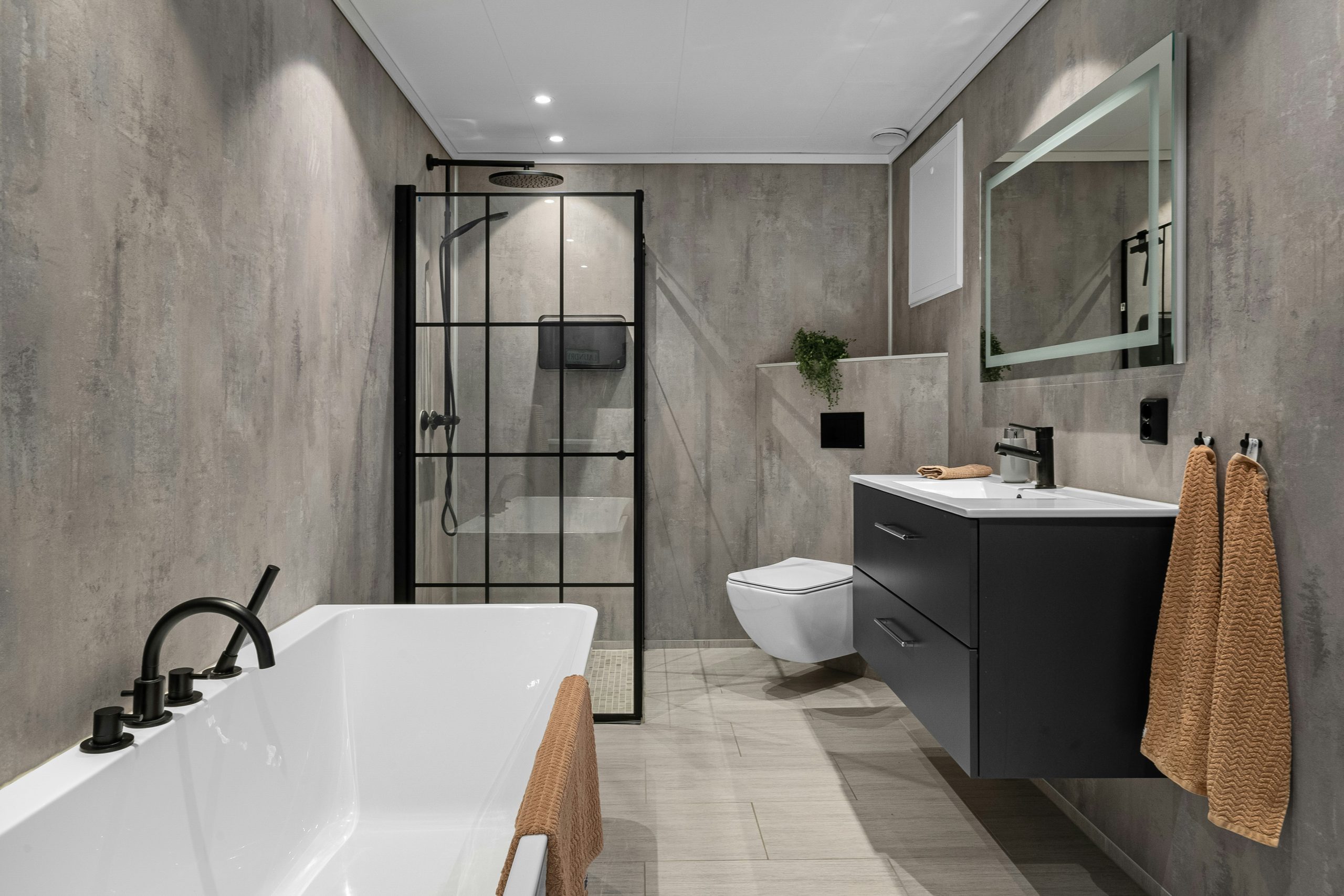 A bathroom with a large bathtub next to a toilet